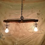 Rustic hanging light fixture made from and old plowing yoke
