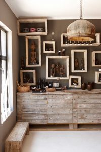 Namibian statuettes and pottery on framed shelves