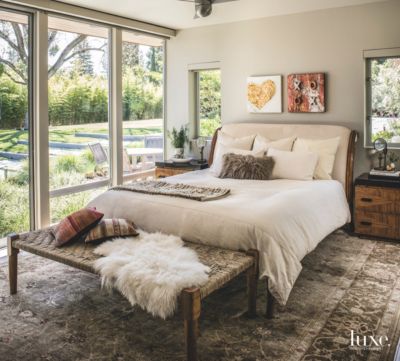 Antique Rug Master Bedroom with Fluffy Pillows and Throw with Artwork