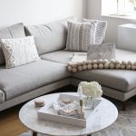 NYC Living Room Apartment - grey sectional sofa with a marble coffee table