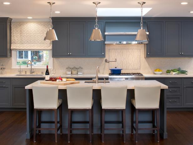 Transitional Kitchen With Blue Cabinets and White Barstools