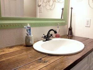I needed a cheap solution for the vanity top in our bathroom, and wood  seemed like the logical choice. If sealed properly, it is durable and has  the added