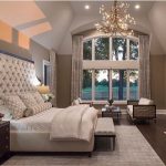 Check out that fabric headboard. Love the high ceilings and the arched  window