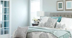 neutral bedroom with soft blue walls