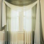 This is grey and white modern curtain design which is light in fabric. Two  extra curtains are kept over rod with the help of which downfall layer is  given