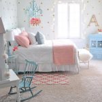 We love how the blue hanging chandelier, rocking chair and dresser all  perfectly match in this preteen girls bedroom.