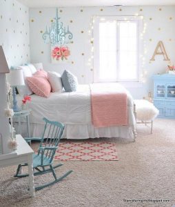 We love how the blue hanging chandelier, rocking chair and dresser all  perfectly match in this preteen girls bedroom.