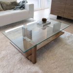 A great example of a modern glass/wood coffee table. The design is  streamlined, allowing the quality of the materials used to shine through.