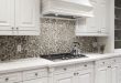 Kitchen with a honeycomb mosaic tile backsplash in a variety of shades.
