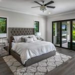Example of a large minimalist master medium tone wood floor and gray floor  bedroom design in