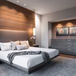 Large minimalist master dark wood floor and brown floor bedroom photo in  Other with beige walls