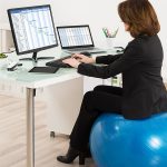 Businesswoman Sitting On Ball chair Working In Office