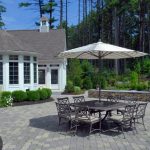 Paver Patio with Outdoor Dining Area and Umbrella