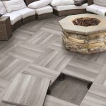 Elevated patio tile floor by Serenissima with a fire pit installed on it