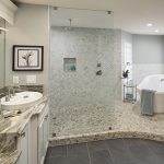 Remodeled master bathroom with rain showerhead and standalone tub