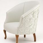 Small white armchair with beautiful fabric detailing on the back.  Upholstered Chairs, Sofa Chair