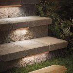Low-profile contemporary stair lighting under treads of outdoor