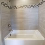 bathtub with tile and tile accent