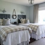 View in gallery Country guest room with rustic wood head boards on twin beds