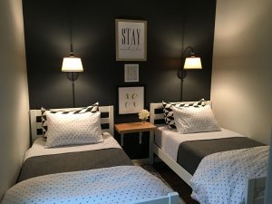 Small guest room with two twin beds. More