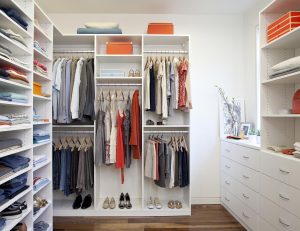 White Themed Walk in Closet with Drawers Shelving and Closet Rods