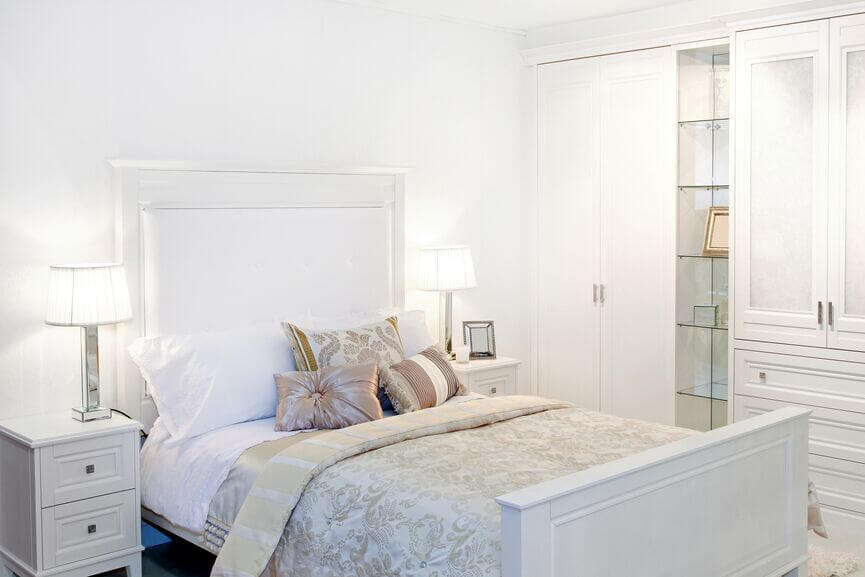 This glamorous room uses subtle, muted accents to offset the use of some  much white