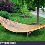 Sleek modern garden furniture made of wood and varnished. - Stock Image