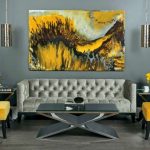 refined living room in grey shades looks bolder with yellow chairs and a  painting